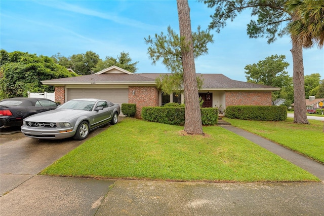 single story home with a garage and a front lawn