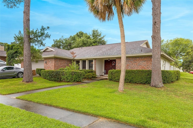 ranch-style home featuring a front yard and a garage