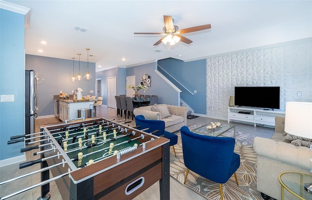 living room featuring ceiling fan and ornamental molding