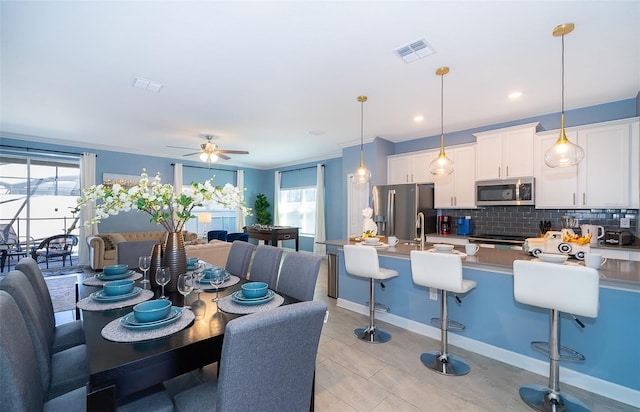 dining space with light tile patterned flooring, plenty of natural light, and ceiling fan