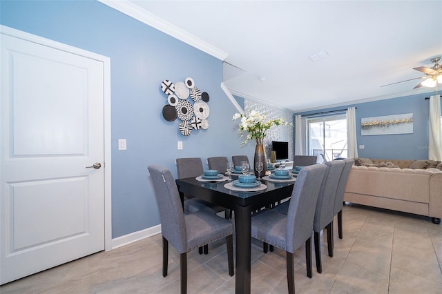 tiled dining room featuring ceiling fan and crown molding