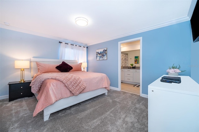 bedroom with dark carpet, ensuite bath, and ornamental molding