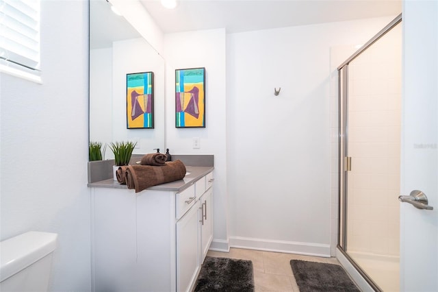 bathroom with tile patterned floors, toilet, an enclosed shower, and vanity