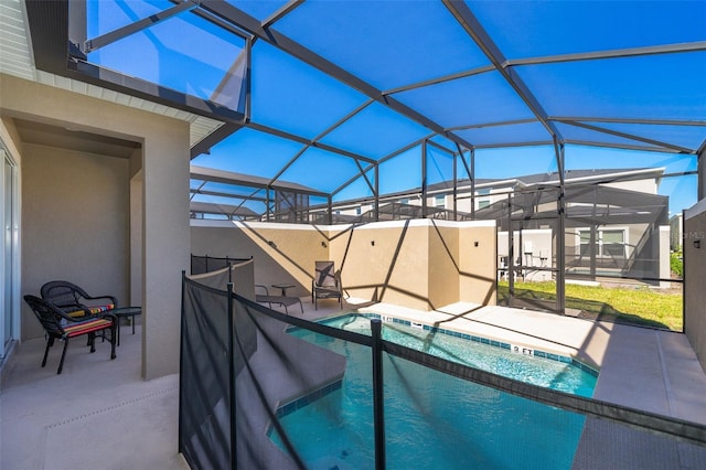 view of swimming pool featuring a lanai and a patio area