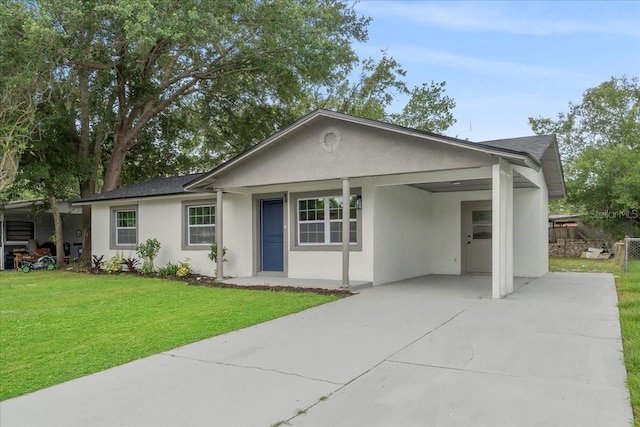 ranch-style home featuring a front yard and a carport