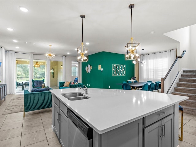 kitchen with decorative light fixtures, gray cabinets, stainless steel dishwasher, and sink