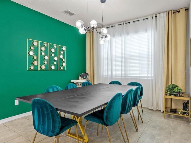 tiled dining room with a notable chandelier