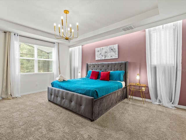 bedroom featuring carpet floors, a textured ceiling, and an inviting chandelier