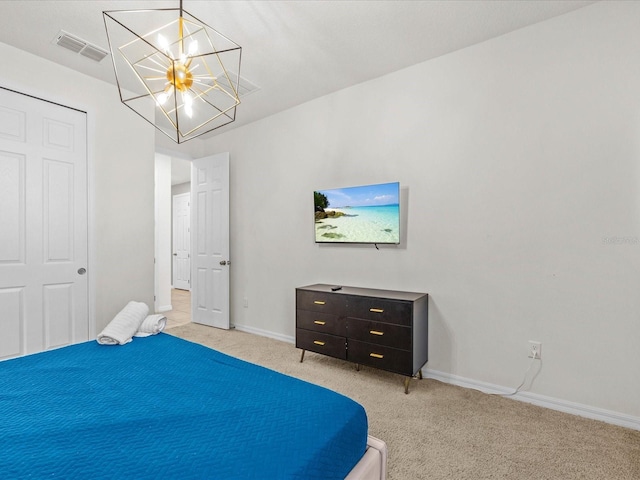 carpeted bedroom with an inviting chandelier