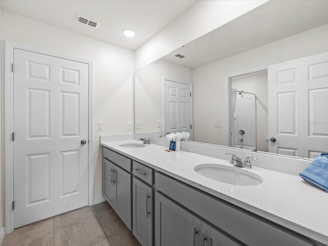 bathroom with tile patterned flooring and vanity