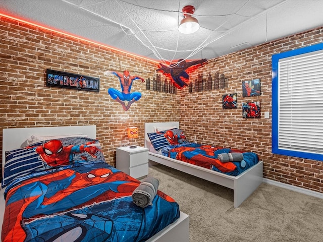 carpeted bedroom with ceiling fan, brick wall, and a textured ceiling