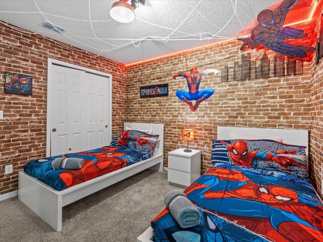 carpeted bedroom with brick wall