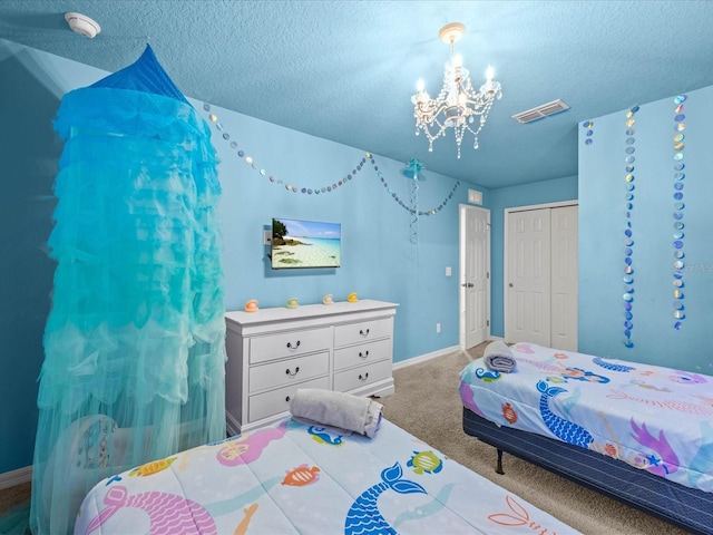 bedroom with a closet, carpet floors, a chandelier, and a textured ceiling