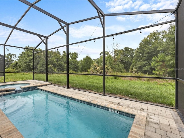 view of swimming pool featuring a lanai, an in ground hot tub, and a patio