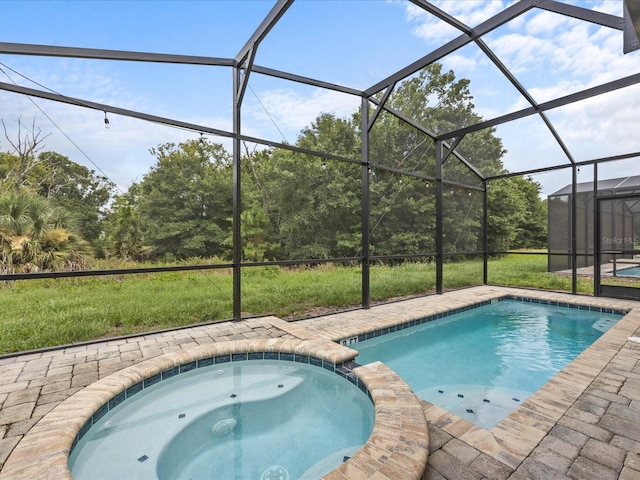 view of swimming pool with an in ground hot tub and glass enclosure