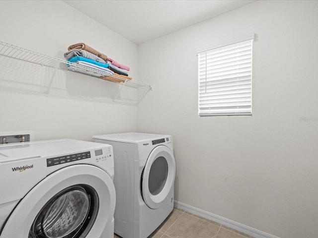 laundry room featuring washing machine and clothes dryer and light tile patterned floors