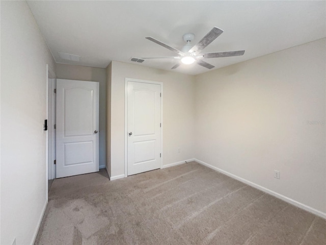 unfurnished bedroom with ceiling fan and light carpet