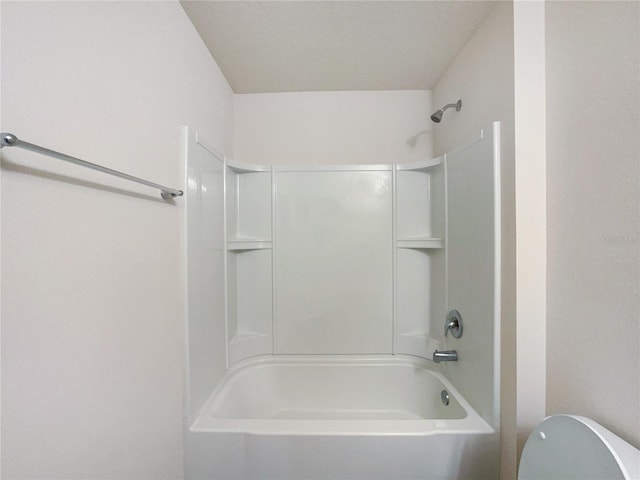 bathroom featuring toilet and shower / washtub combination