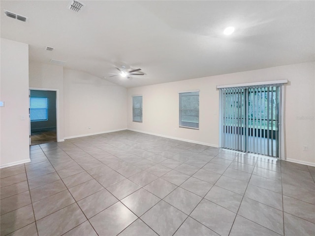 empty room with ceiling fan, light tile patterned flooring, and lofted ceiling