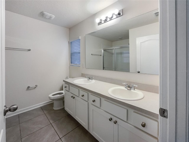 bathroom with tile patterned flooring, an enclosed shower, a textured ceiling, toilet, and vanity