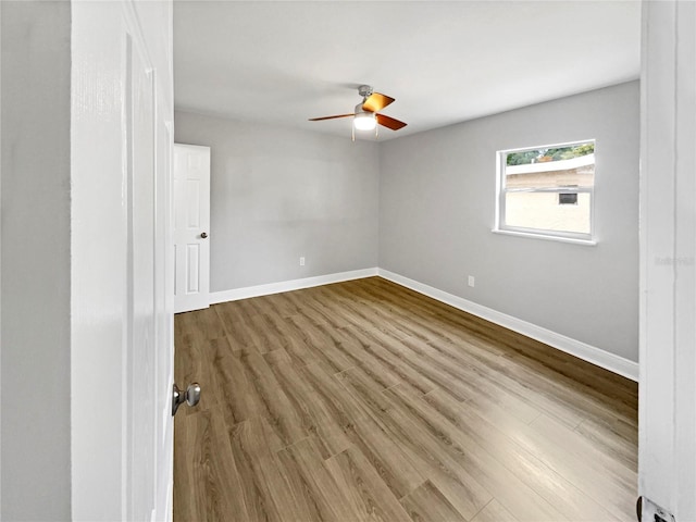 spare room with hardwood / wood-style flooring and ceiling fan