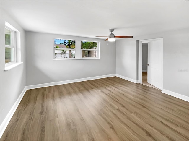 empty room featuring wood-type flooring and ceiling fan