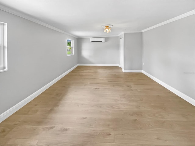 unfurnished room with light wood-type flooring, an AC wall unit, and crown molding