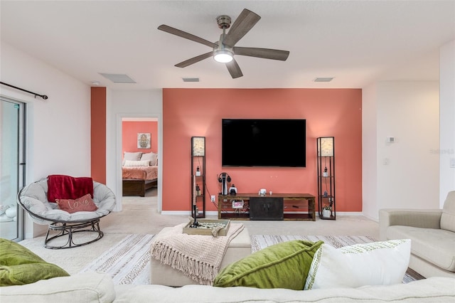 living room featuring ceiling fan and light colored carpet