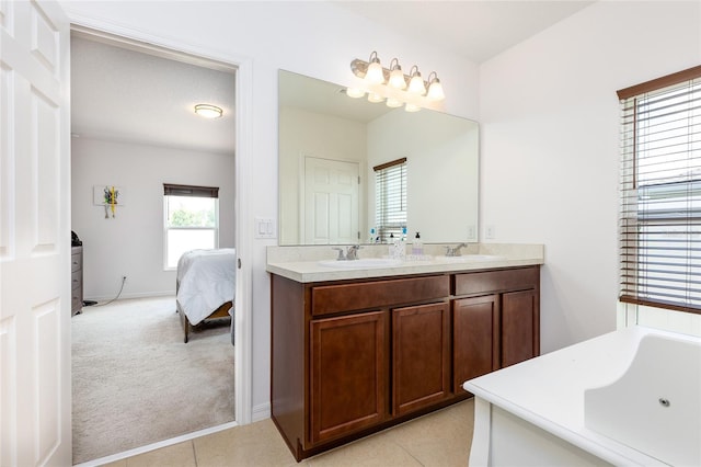 bathroom with vanity, a bathing tub, and tile patterned flooring