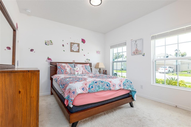 carpeted bedroom with multiple windows