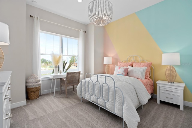 carpeted bedroom featuring an inviting chandelier