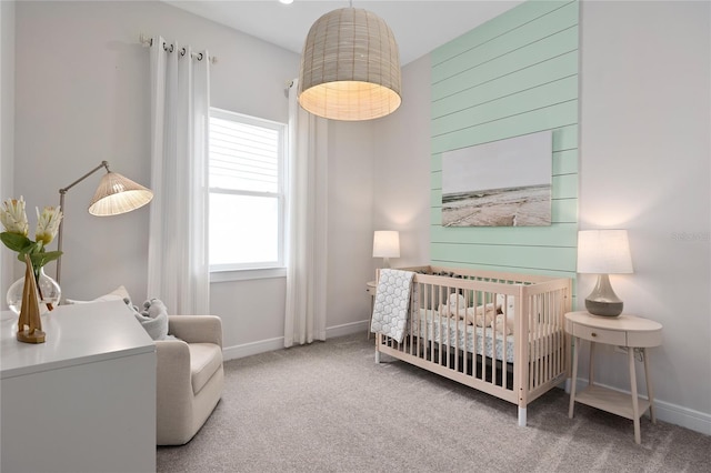 carpeted bedroom with a crib