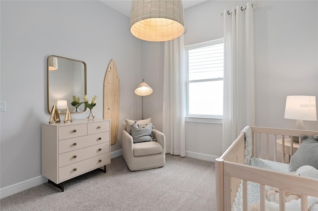 carpeted bedroom featuring a crib