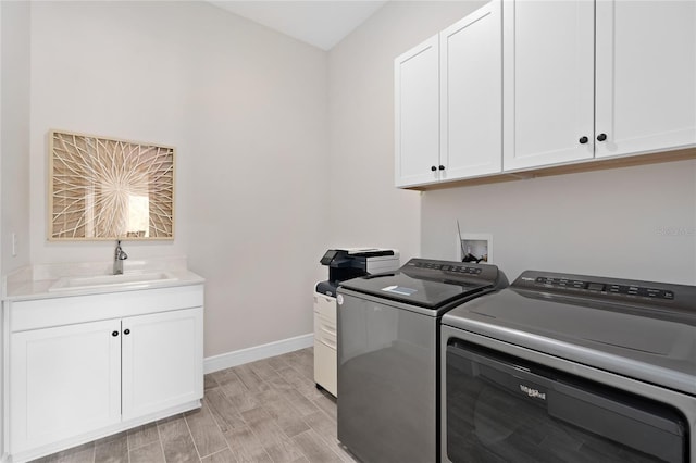 laundry area with cabinets, sink, and washing machine and clothes dryer