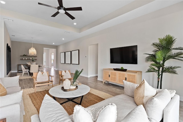 living room with ceiling fan and hardwood / wood-style flooring