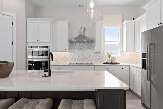 kitchen featuring tasteful backsplash, white cabinets, and stainless steel appliances