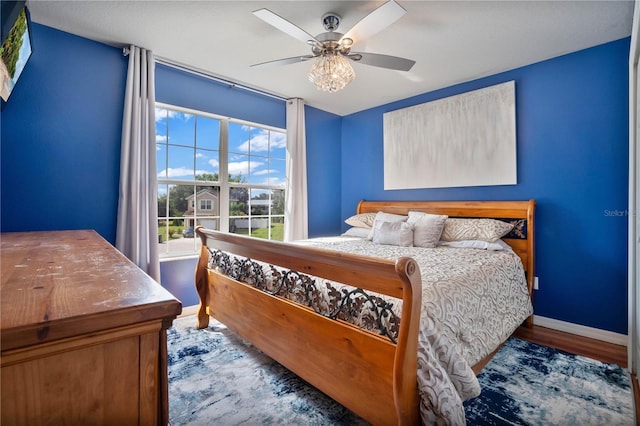 bedroom featuring dark wood-type flooring and ceiling fan