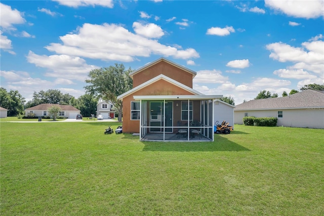 back of house with a sunroom and a lawn