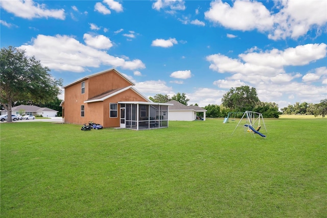 view of yard with a sunroom and a playground