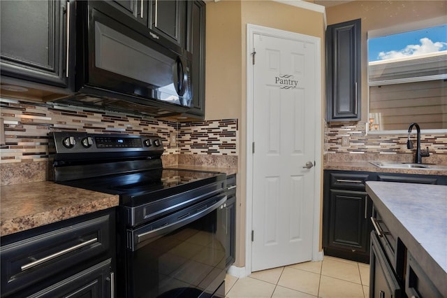 kitchen with sink, decorative backsplash, black appliances, and light tile patterned floors