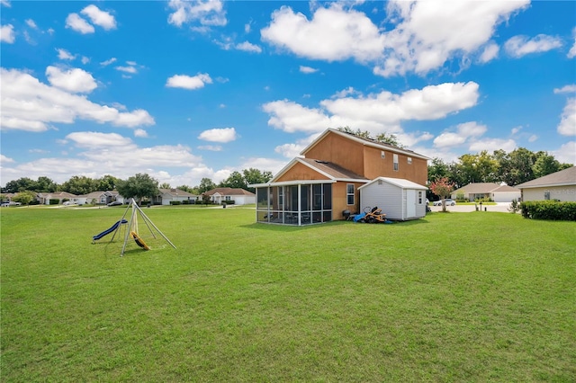 back of property featuring a yard and a sunroom