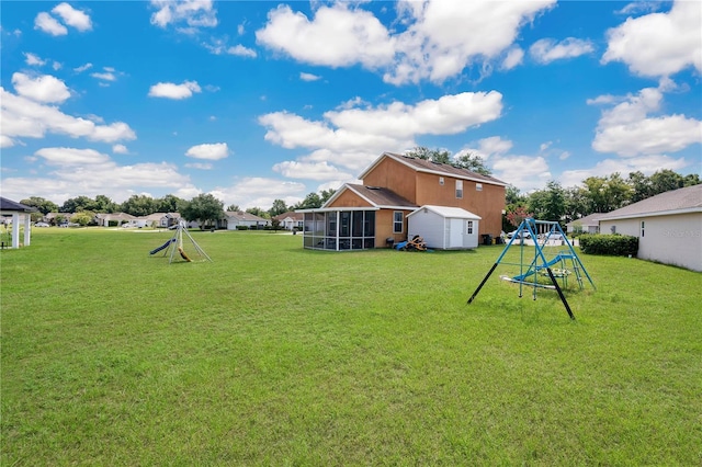 view of yard featuring a sunroom and a playground