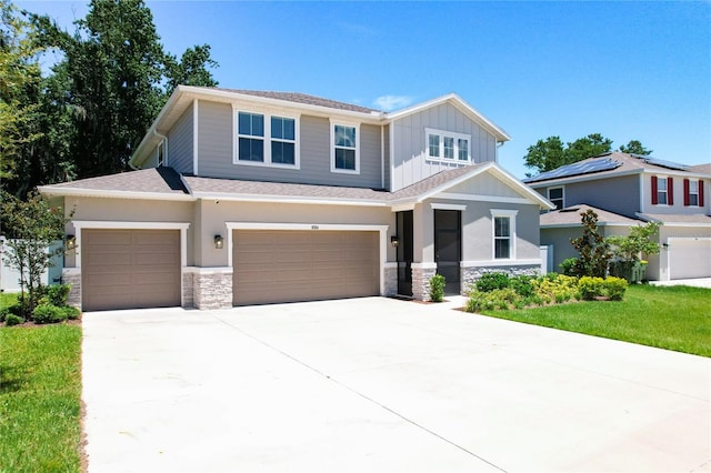 view of front of house featuring a front yard and a garage