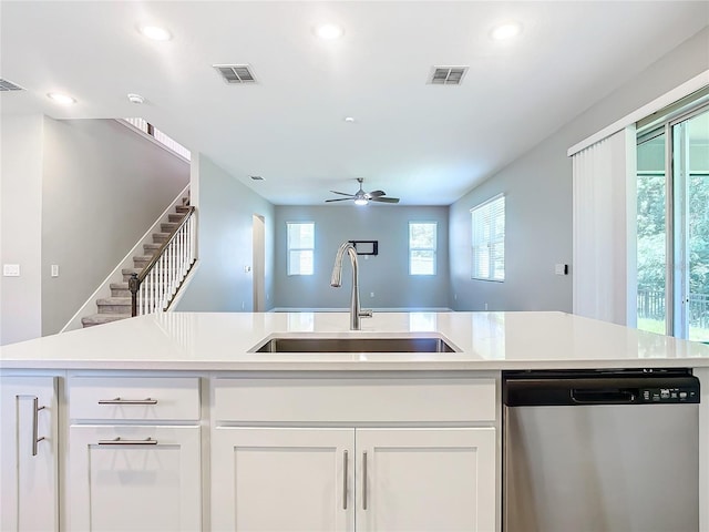 kitchen featuring dishwasher, white cabinets, ceiling fan, and sink