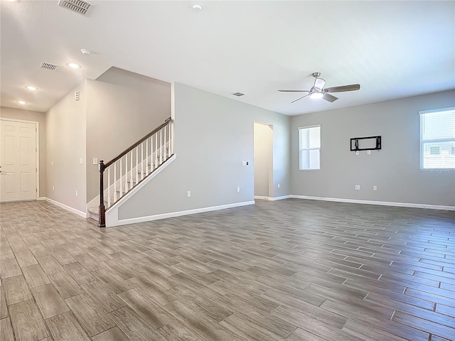 unfurnished living room with ceiling fan and plenty of natural light