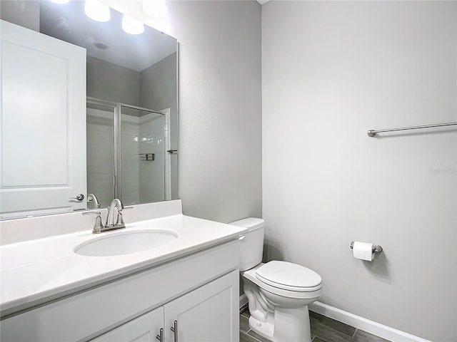 bathroom featuring vanity, toilet, and walk in shower