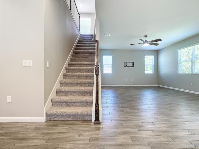 stairway with ceiling fan