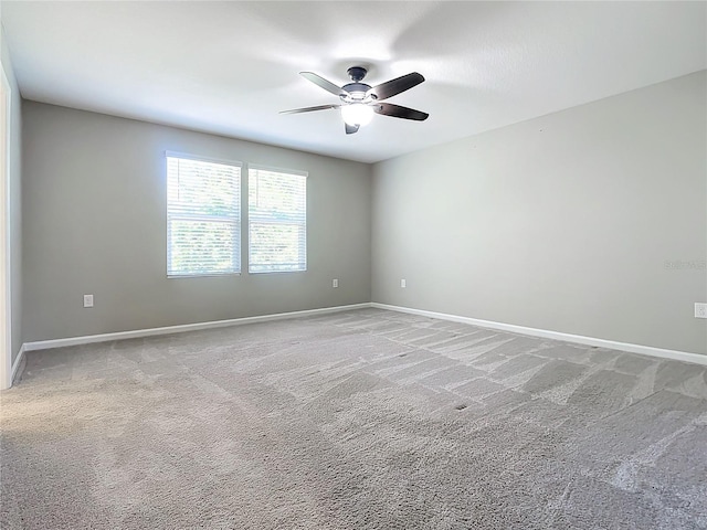 unfurnished room with ceiling fan and carpet floors