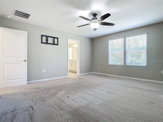 unfurnished room featuring ceiling fan and light carpet