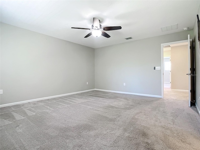 carpeted spare room with ceiling fan